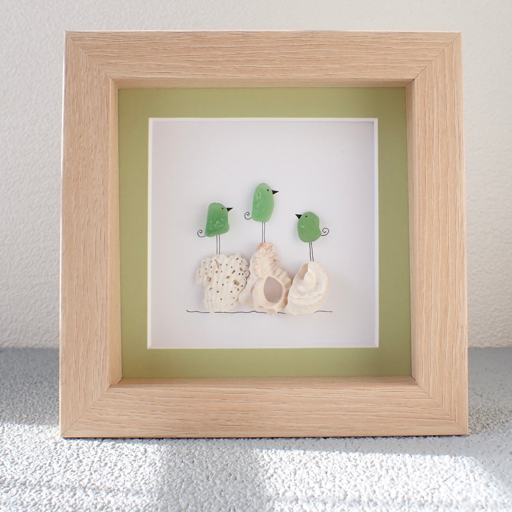 
                  
                    framed picture of Three Colorful Sea Glass Birds on Washed shells and coral
                  
                