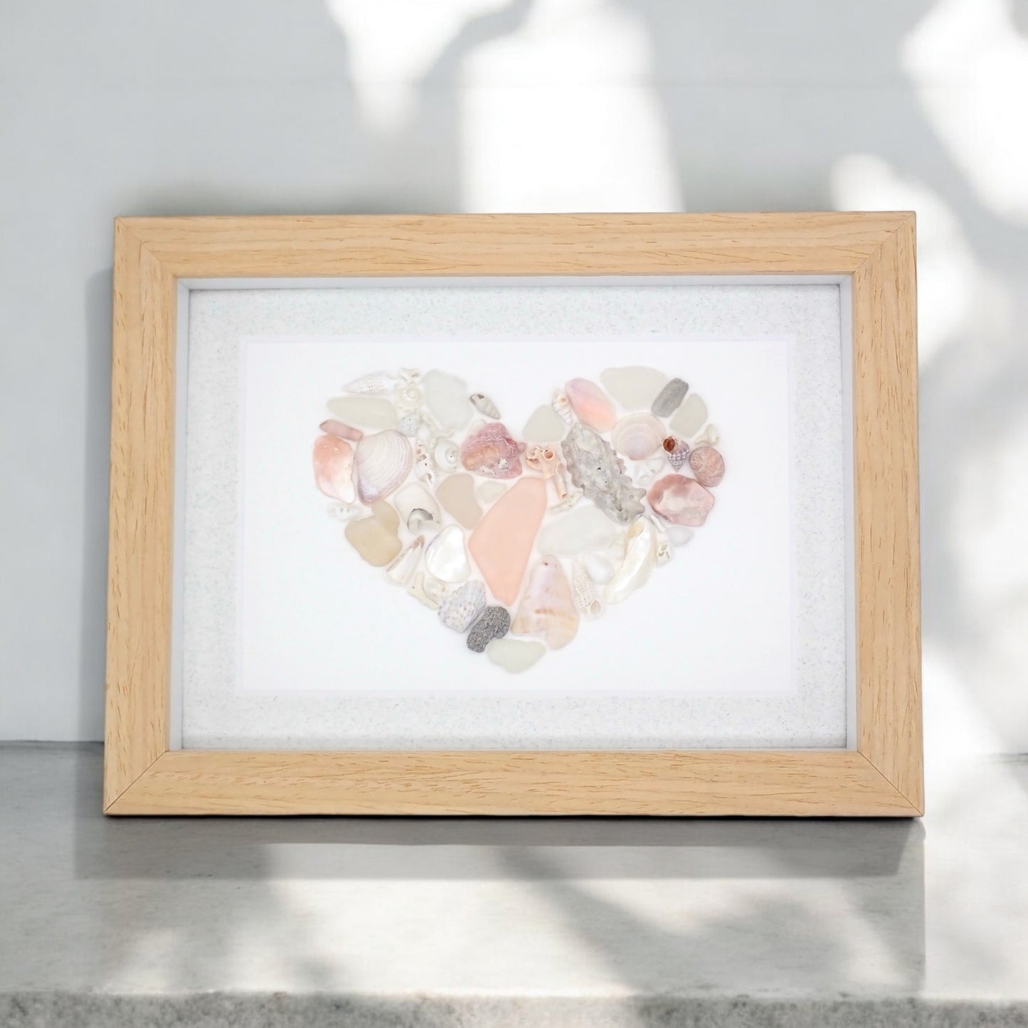 sea glass art features a seashell mosaic composed of shells, sea glass, &amp; coral