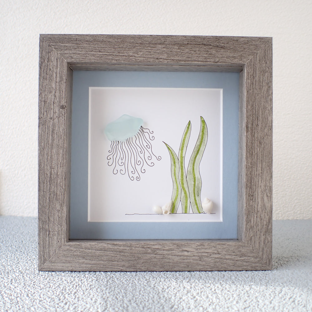 framed sea glass jellyfish picture with seaweed and shells