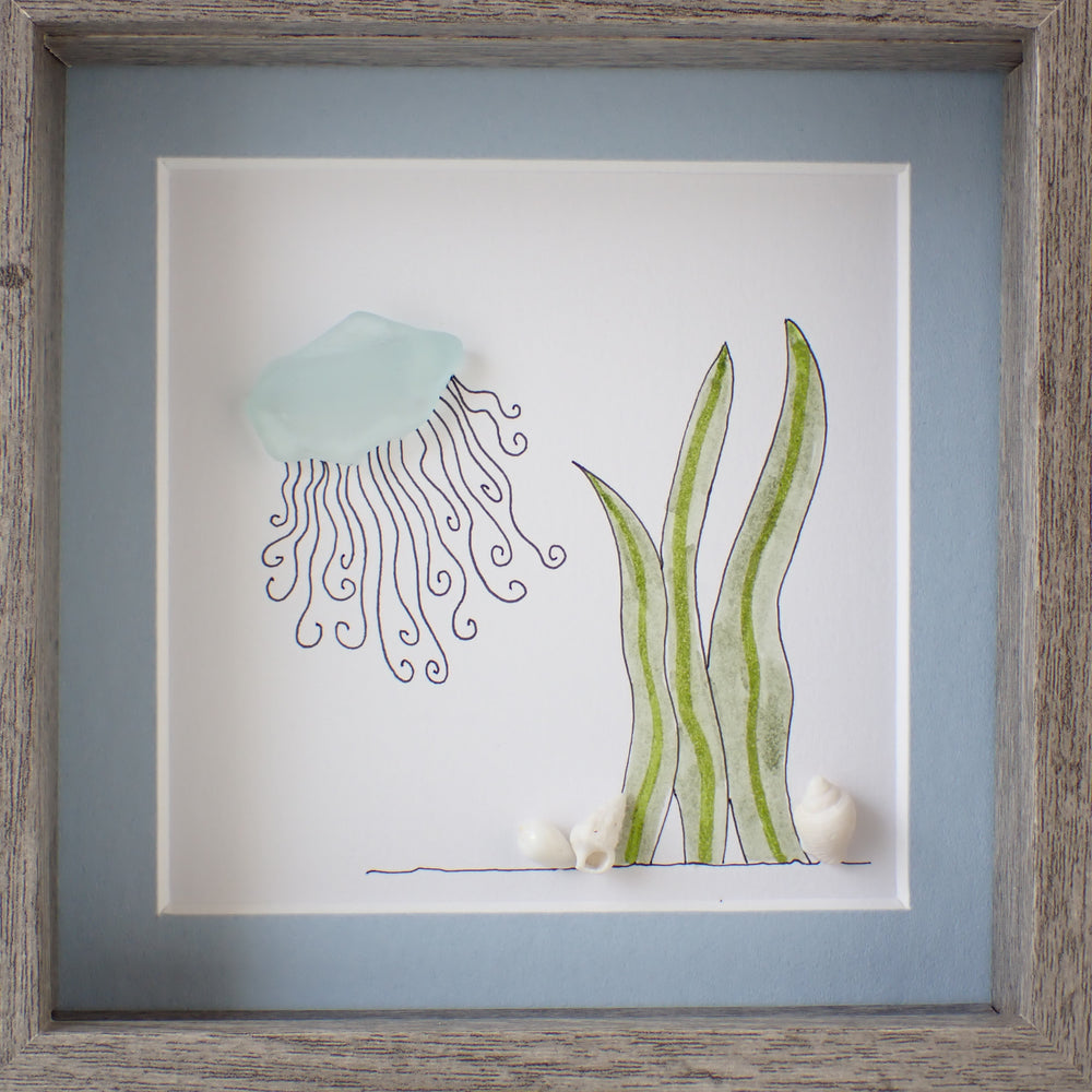 framed sea glass jellyfish picture with seaweed and shells